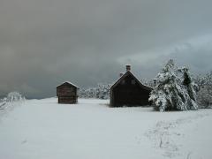 A snowy winter view of the Jacob Ebey House and smaller blockhouse at Ebey's Landing National Historical Reserve
