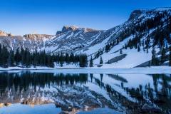 Patchy snow on the flanks of mountains reflected in a lake along Wheeler Peak Scenic Drive, Great Basin National Park
