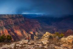 A morning snow storm with dramatic clouds and sunlight at Yaki Point on the South Rim of Grand Canyon National Park