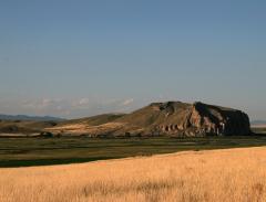 Beaverhead Rock behind a golden field and underneath a wide open sky, Lewis and Clark National Historic Trail