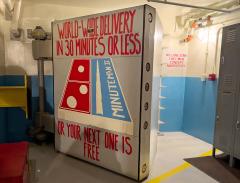 A thick metal door with the painting that looks like a Domino pizza box but instead has a drawing of a missile on it, Minuteman Missile National Historic Site