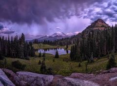 Blue hour landscape of Tipsoo Lake and Mount Rainier underneath a sky of clouds with visible rain coming down, Mount Rainier National Park