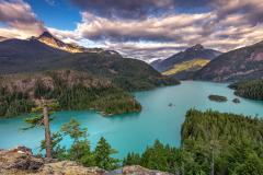 Early morning clouds over the mountains and brilliant turquoise water of Diablo Lake, North Cascades Complex, Ross Lake National Recreation Area