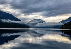 Lake Crescent in Olympic National Park, with mountains in the background wreathed in clouds