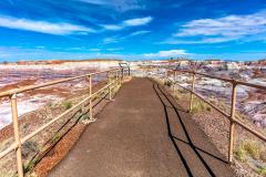a leading line image of a paved walkway toward a panoramic overlook at Blue Mesa, Petrified Forest National Park