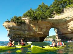Kayakers on Lake Superior near a rock arch known as Lovers Leap, Pictured Rocks National Lakeshore