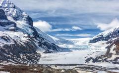 A view of the white ice and snow of Athabasca Glacier with clouds above, Jasper National Park, Canada