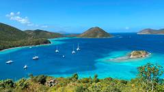 A view overlooking a bay of turquoise-blue water surrounded on three sides by beaches and tropical trees, Virgin Islands National Park