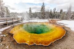 A snowy autumn morning at Morning Glory Pool in Yellowstone National Park in Wyoming