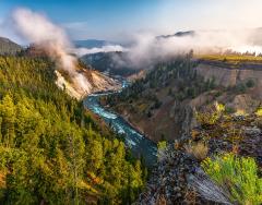 An early morning, wide-angle view looking down on the steaming Calcite Springs and the Yellowstone River in Yellowstone National Park
