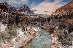 A mid-morning view of February winter snow over the Virgin River and Watchman Peak in Zion National Park, Utah